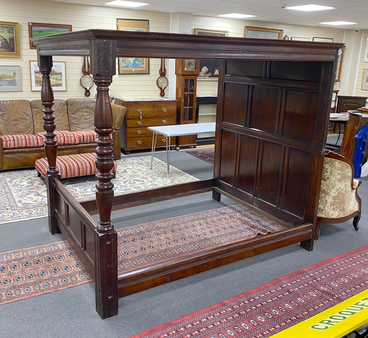 An 18th century style oak four poster bed with panelled canopy, width 162cm, length 221cm, height 194cm